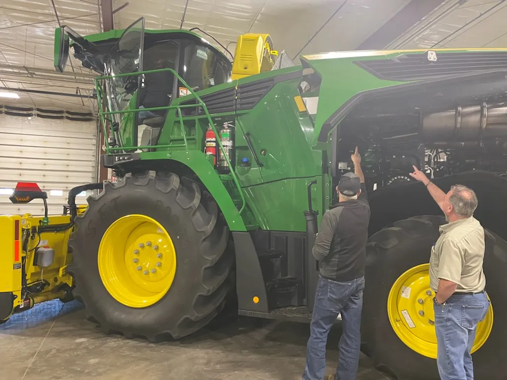 Customers looking over a John Deere combine at East Texas Equipment